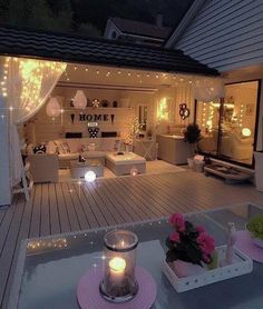 an outdoor living area is lit up with fairy lights