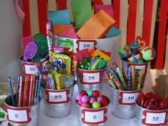 candy buckets filled with candy and candies on a table