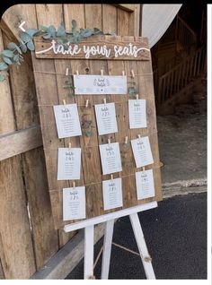 a wooden sign with seating cards attached to it