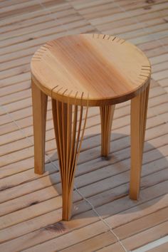 a small wooden table sitting on top of a hard wood floor