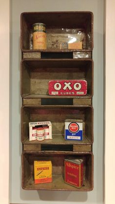 an old wooden shelf with spices and other items on it's sides, hanging from the wall