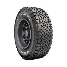 an all terrain truck tire with black rim and white lettering on the front tires are shown