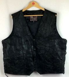 Leather Club genuine leather vest Men's size 54 Approximate measurements - taken while laying flat: Length in back - collar to bottom of vest - 24.5 in. Front of vest has two points - length from collar to points in front - 27 in. Shoulder to shoulder - 18.5 in. Underarm to underarm- 27 in. Vest is laced up both sides with leather lacing and eyelets - some of the eyelets have paint chips Front close with 4 snaps Front has 2 slit pockets Inside is lined and has 2 slit pockets Leather is a patchwo Leather Lacing, Texas Chainsaw, Leather Pattern, Paint Chips, Leather Vest, Patchwork Designs, Chainsaw, Vest Dress, Leather And Lace