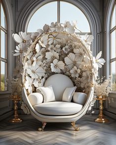 a white chair sitting in front of a large window with flowers on it's back