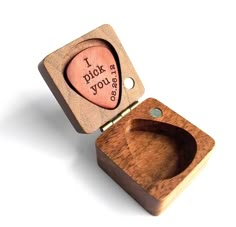 a wooden box with a heart shaped stamp on the lid that says i pick you