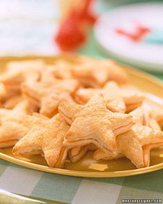 star shaped cookies are on a yellow plate