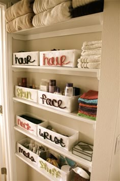 the shelves are organized with towels and other items