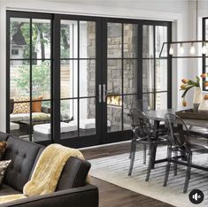 a living room filled with furniture next to a dining room table and glass sliding doors