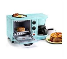 a blue toaster oven sitting next to a stack of pancakes