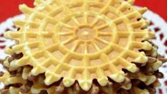 a close up view of some waffles on a white doily with red background