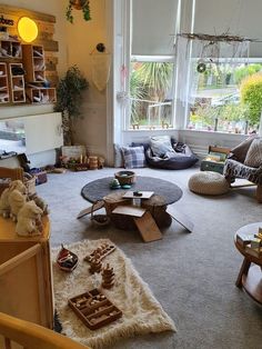 a living room filled with lots of furniture and decor on top of carpeted flooring