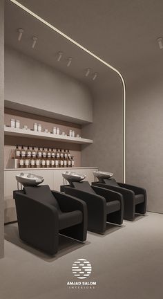 the interior of a salon with black chairs and white counter tops, along with candles on shelves