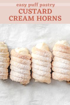 four puff pastry custard cream horns are lined up on a white surface with the words easy puff pastry custard cream horns