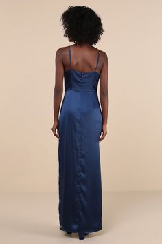 the back of a woman wearing a blue dress