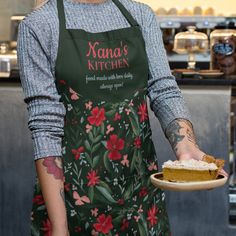 a woman in an apron holding a piece of pie