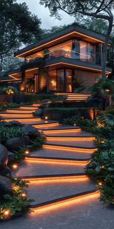 a house is lit up with lights and steps leading to the upper level deck area