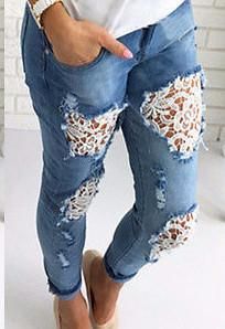 a woman wearing ripped jeans with lace detailing