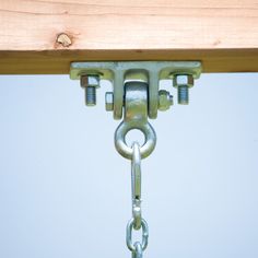 a metal chain is attached to a wooden beam