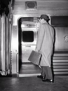 size: 12x9in Photographic Print: 1950s BACK VIEW OF A MAN BUSINESSMAN CARRYING LEATHER BRIEFCASE WEARING TOP COAT AND HAT COMMUTE... by Panoramic Images : 1950s Man, 1950s Men, 1950s Mens, Flannel Suit, Vintage Business, Vintage Suits, Briefcase For Men, Back View, Mens Winter Fashion