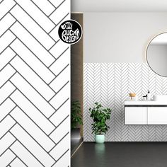 there is a bathroom with white and black tile on the walls, along with a round mirror