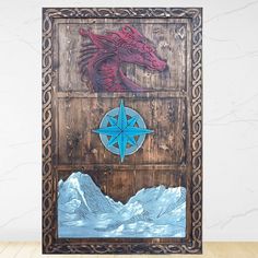 a wooden panel with an image of a dragon and a compass on it, in front of a white wall