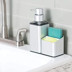 a soap dispenser and sponge holder sit on the edge of a sink