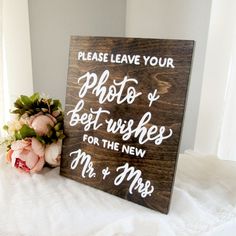 a wooden sign that says please leave your photo and best wishes for the new mr & mrs