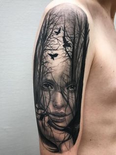 a woman's face with trees and birds in the background on this half sleeve tattoo