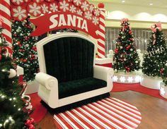 christmas decorations are displayed in the lobby of santa's office, which is decorated with red and white candy canes