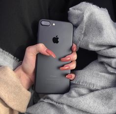 a woman holding an iphone in her hands