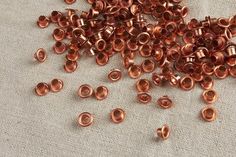 some copper colored beads are laying on a table