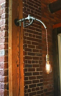 a light that is on the side of a brick wall