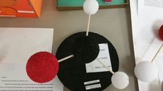 an assortment of objects are on display in a museum setting, including balls and sticks