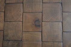 a close up view of wood flooring with knots in the center and one knot at the end