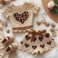 two pieces of crocheted clothing and accessories laid out on a white furnishing