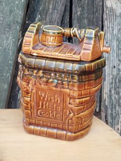 a ceramic cookie jar sitting on top of a wooden table