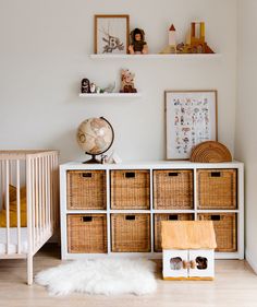 a baby's room with wicker baskets on the dresser