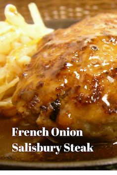 french onion salisbury steak with macaroni and cheese on the side, served in a cast iron skillet