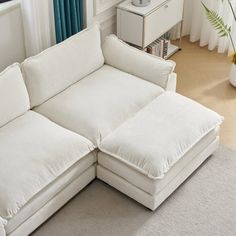 a white sectional couch in a living room