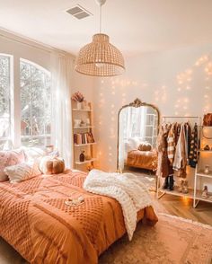 a bed room with a neatly made bed and lots of lights hanging from the ceiling