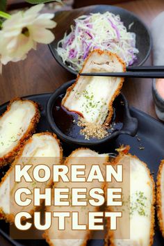 korean cheese cutlet on a black plate with chopsticks and flowers in the background