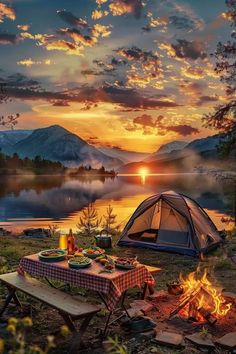 a tent is set up next to a campfire and picnic table with food on it