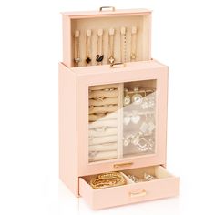 a pink jewelry box filled with lots of different items