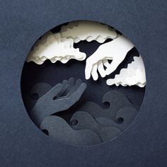 two hands reaching for each other in the middle of a circular cutout with clouds