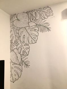 the wall is decorated with black and white leaves