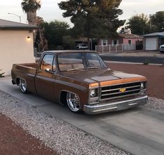 a brown truck parked in front of a house