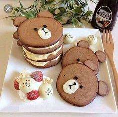 there is a plate that has some cookies on it and bears in the shape of pancakes