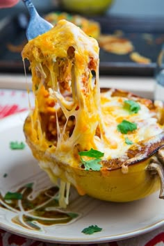 a close up of a food dish on a plate with a fork sticking out of it