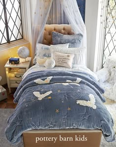 a bed room with a neatly made bed and lots of pillows on top of it