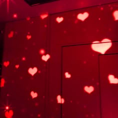 a red room with hearts projected on the wall